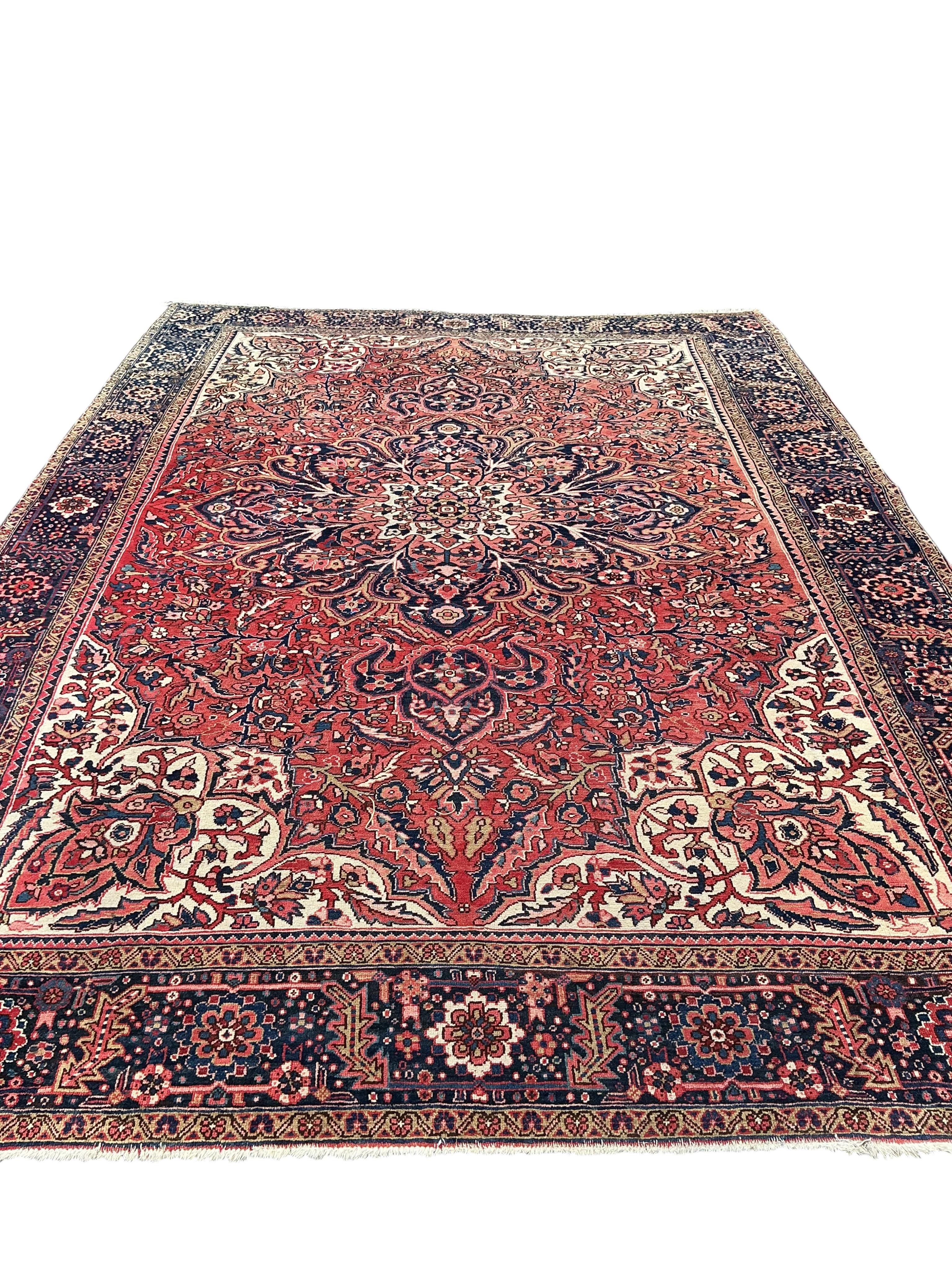 A Heriz red ground carpet, 295 x 270cm